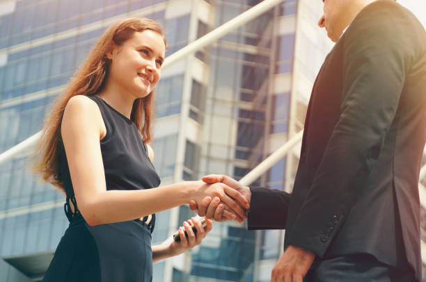 istock Businesswoman shaking hands with client 1127252881