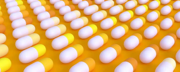 istock even rows of yellow pills on a yellow 1127254228
