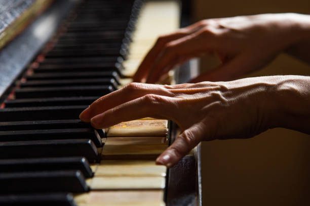 istock Woman pianist at rusty piano 1127254590