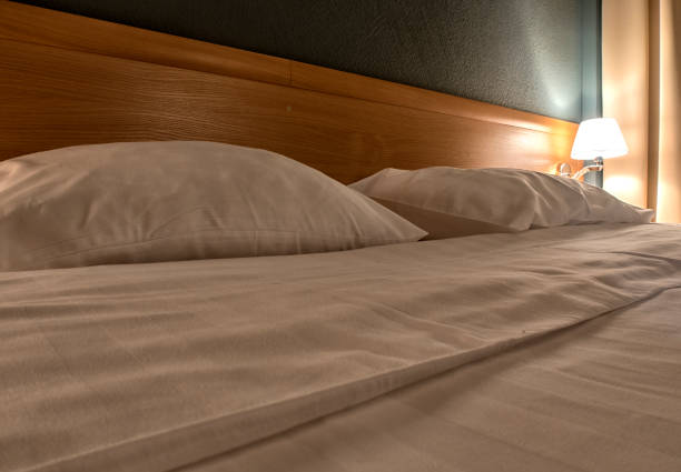 istock comfortable bed in the hotel room, top view. 1127255310