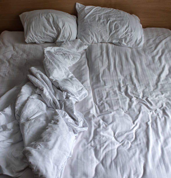 istock comfortable bed in the hotel room, top view. 1127255318