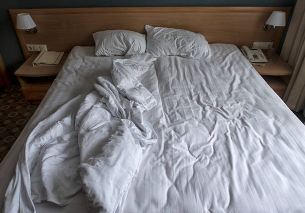 istock comfortable bed in the hotel room, top view. 1127255352