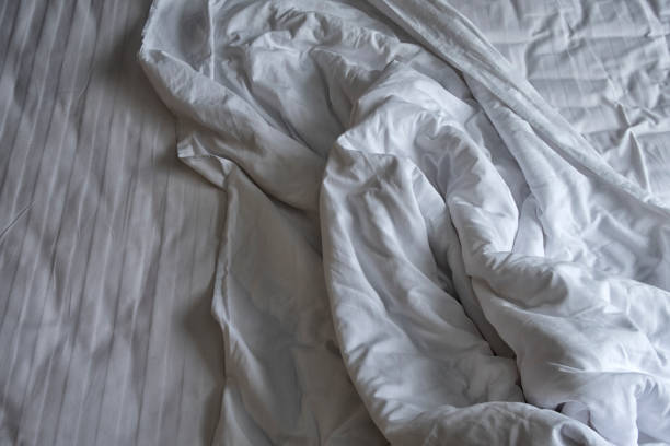 istock comfortable bed in the hotel room, top view. 1127255416