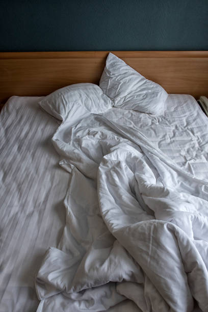 istock comfortable bed in the hotel room, top view. 1127255473