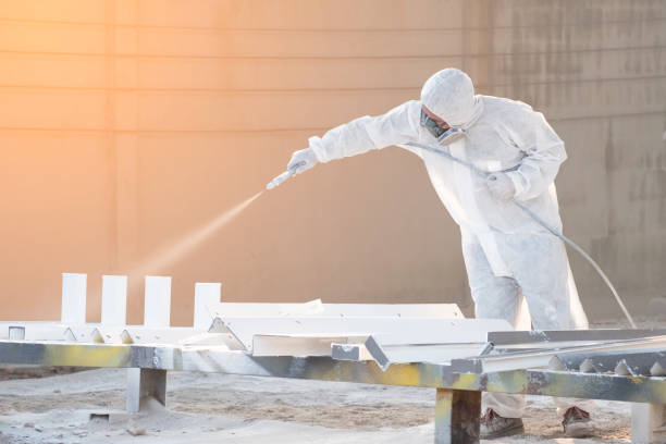 worker painting a mechanical part with airless spray worker painting a mechanical part with airless spray airless stock pictures, royalty-free photos & images