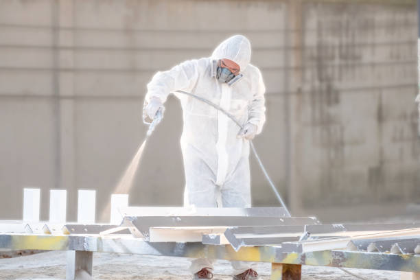 istock worker painting a mechanical part with airless spray 1127255618