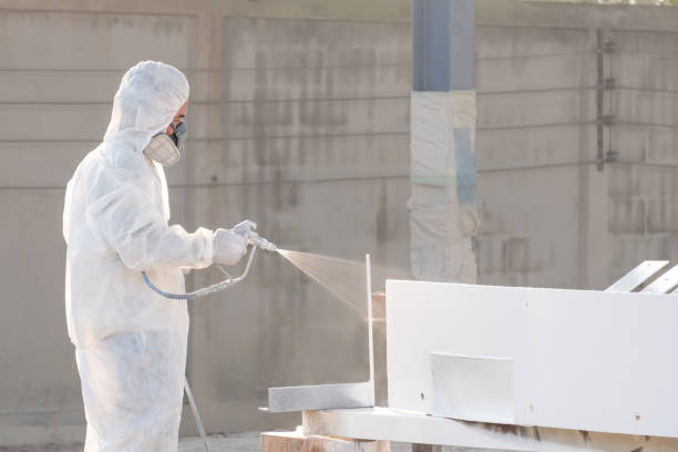 worker painting a mechanical part with airless spray worker painting a mechanical part with airless spray airless stock pictures, royalty-free photos & images