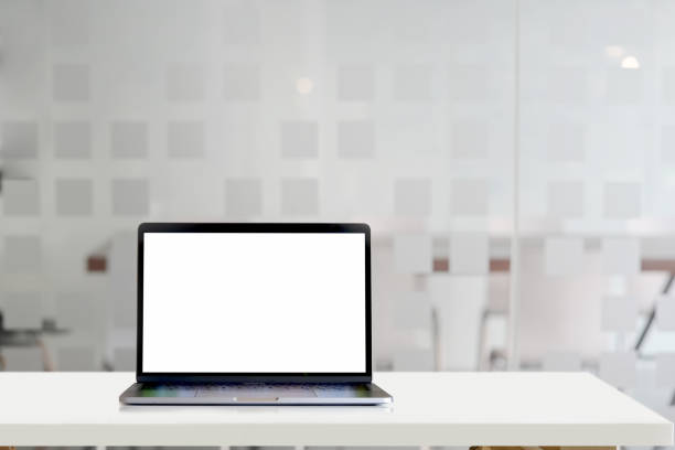 istock Mockup laptop on white wood desk in office background 1127256009