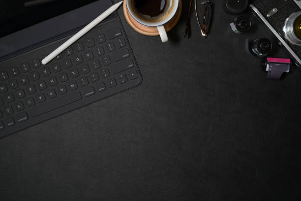 istock Top view photographer leather dark desk with creative supplies and copy space 1127256965