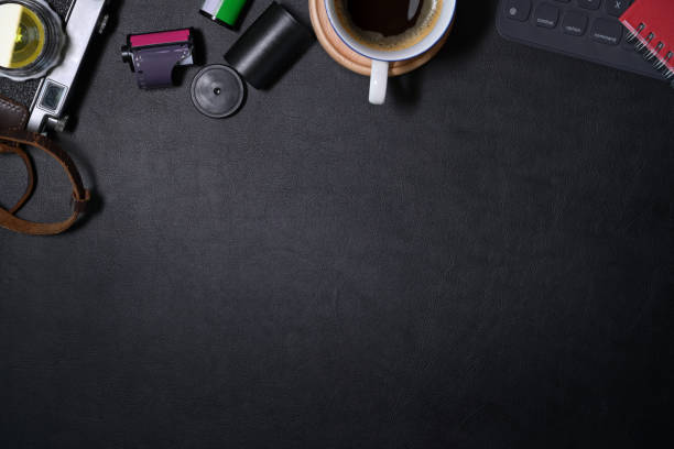 istock Mockup hipster leather dark desk vintage camera with creative supplies and copy space 1127257249