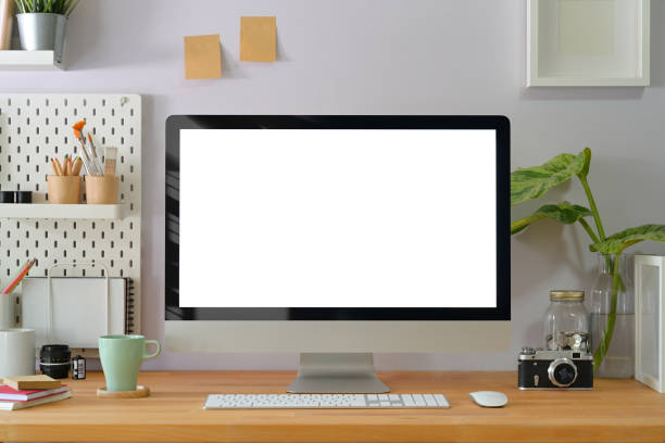 istock Home creative office interior with stylish photographer supplies and computer display 1127257322