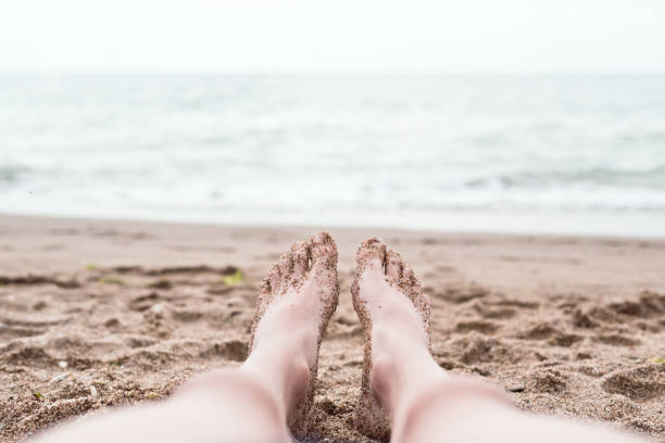 istock Feet on sand near the sea 1127257963