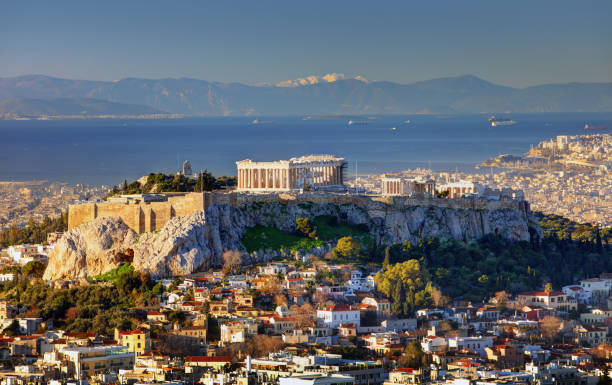 aerial view over athens with te acropolis and harbour from lycabettus hill, greece at sunrise - sunlight sun architectural feature blue imagens e fotografias de stock