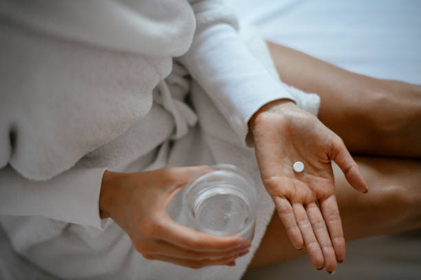 istock Beautiful woman having pills 1127258320