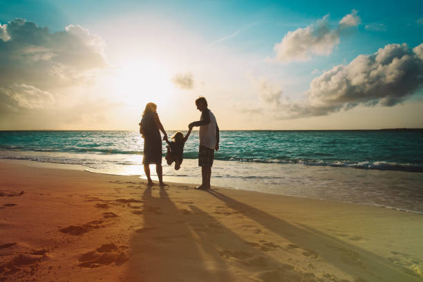 istock happy family with kid play on sunset beach 1127259456