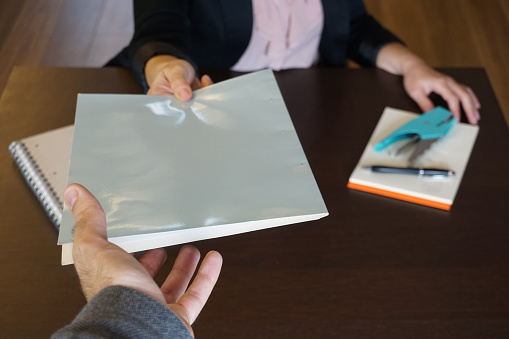 hand of a man receiving documents