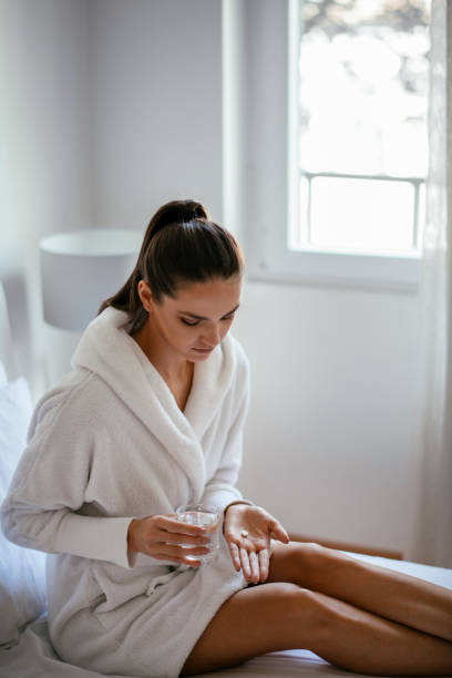 istock Beautiful woman having pills 1127259693
