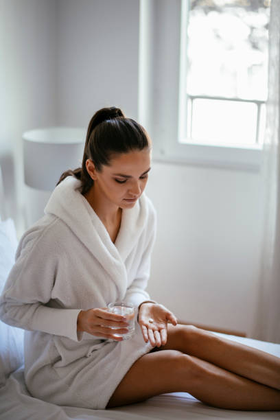 istock Beautiful woman having pills 1127259787