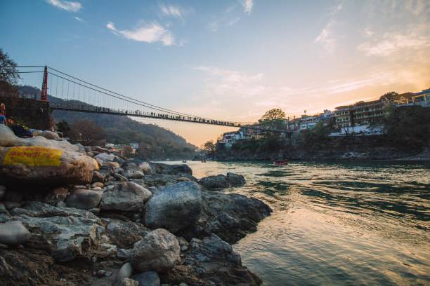 istock Ganga river at the sunset with footbridge abow. 1127260680