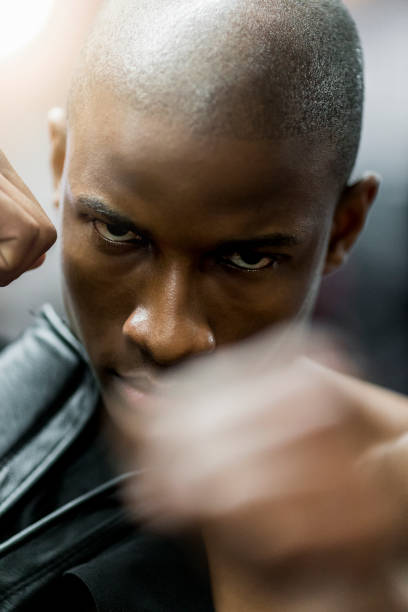 istock Confident male boxer punching in gym 1127260922