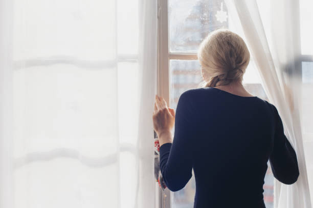istock Romantic girl by the window 1127260942