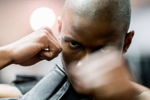 istock Close-up of dedicated boxer punching in gym 1127260949