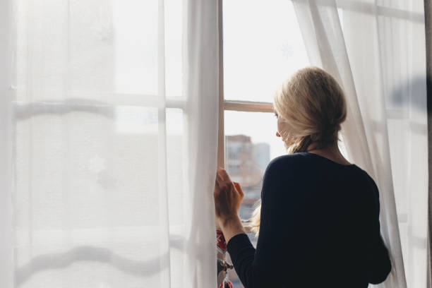 istock Romantic girl by the window 1127260952