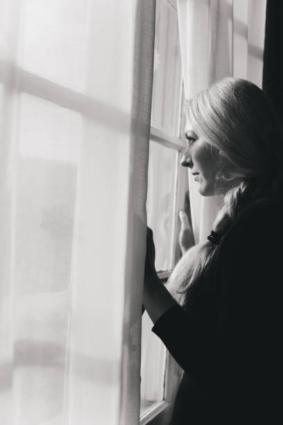 istock Romantic girl by the window 1127260967