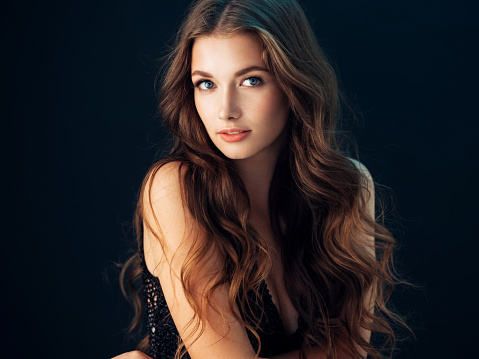 Young beautiful model with long wavy well groomed hair