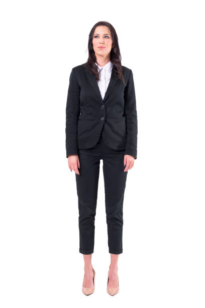 confident businesswoman in black business suit standing with arms down looking up - arms at side imagens e fotografias de stock