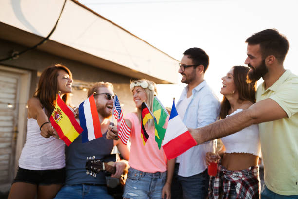 istock Group of happy friends having party on rooftop 1127264461