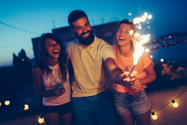 istock Group of happy friends celebrating at rooftop 1127264498