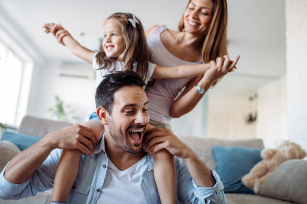 famiglia felice che si diverte a casa - family cheerful happiness domestic life foto e immagini stock