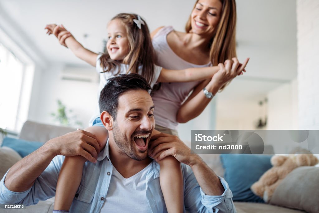 Happy family having fun time at home Happy family having fun time together at home Family Stock Photo