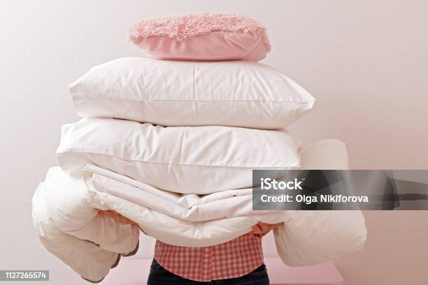 Woman Holding A Pile Of Bedding For Sleeping Household Stock Photo - Download Image Now