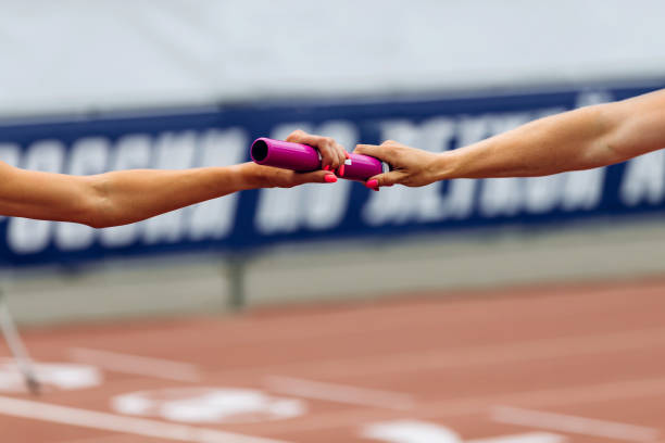 istock relay race racing hands women runners 1127265699