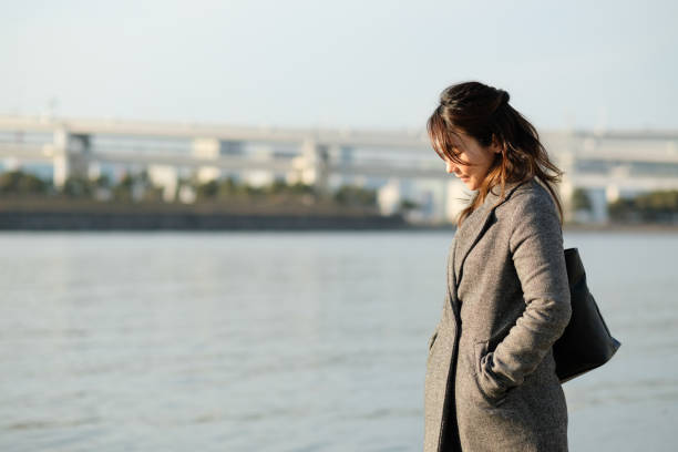 Portrait of businesswoman Portrait of Asian businesswoman outdoor in Winter walking beach women sadness stock pictures, royalty-free photos & images