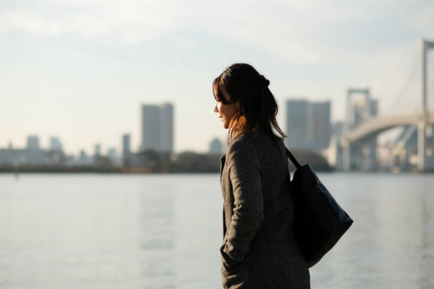 Portrait of businesswoman Portrait of Asian businesswoman outdoor in Winter walking beach women sadness stock pictures, royalty-free photos & images