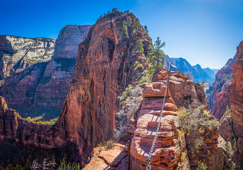 View from the narrow trail of Angel's Landing, the precipitous rocky ridge high above the canyon floor in Zion National Park, Utah, USA.