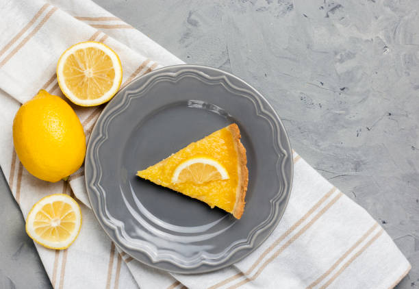 istock Plate with piece of tasty lemon pie on stone background, copy space. 1127273140