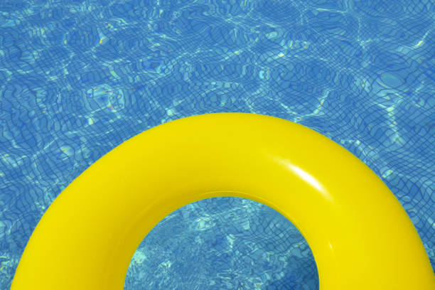 istock Colorful inflatable tube floating in swimming pool 1127275366