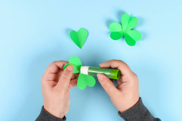 istock DIY green clover St. Patricks Day on blue background. 1127275524