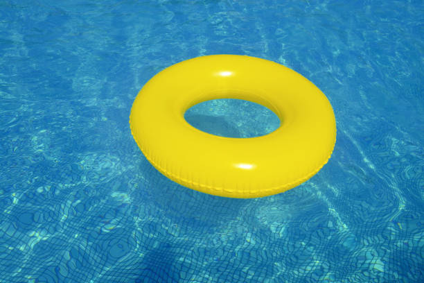 istock Colorful inflatable tube floating in swimming pool 1127275977