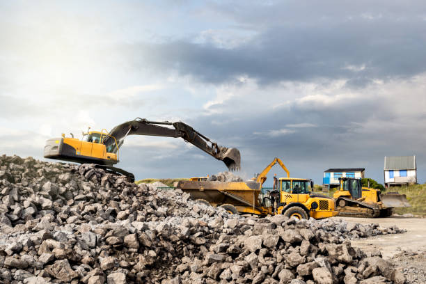 istock Dumper truck and mechanical digger on the beach 1127276175