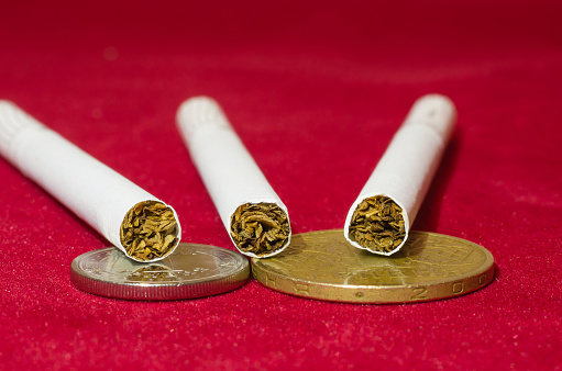 Quit smoking and save money. Still life on red background. Stop smoking.