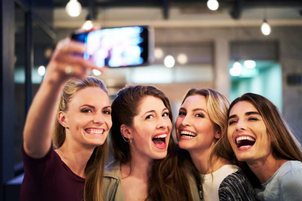 istock Females taking selfie through mobile phone in bar 1127279534