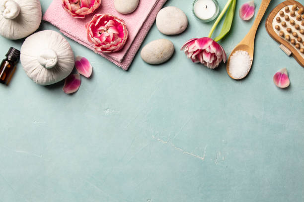 Flat lay of spa treatment set with pink flowers