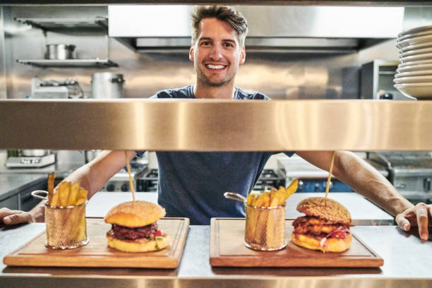 istock Portrait of smiling chef with prepared orders 1127280264