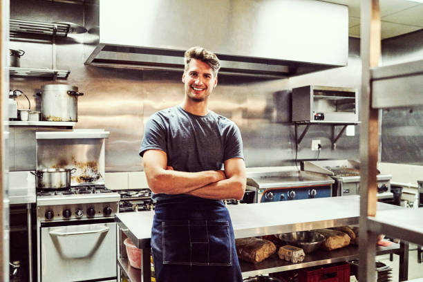 istock Portrait of confident chef standing at kitchen 1127281397