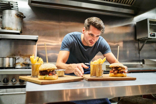 istock Concentrated chef serving food on kitchen counter 1127281981
